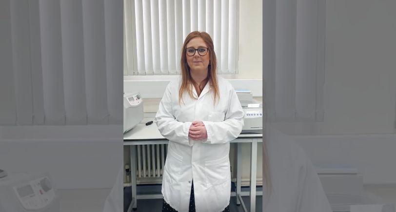 Thumbnail for video of lab walktthrough featuring woman in lab coat and with together in lab