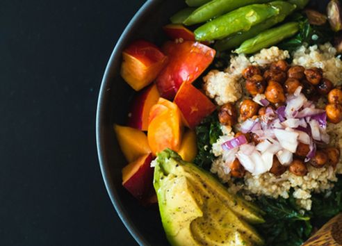 Close up of salad bowl containing high fibre foods, including chickpeas and avocado
