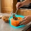 Woman putting food in a plastic container