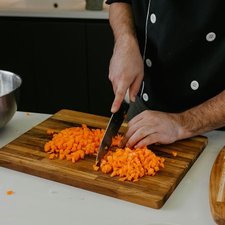 Man chopping carrots
