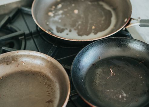 Dirty frying pans on gas hov oven top