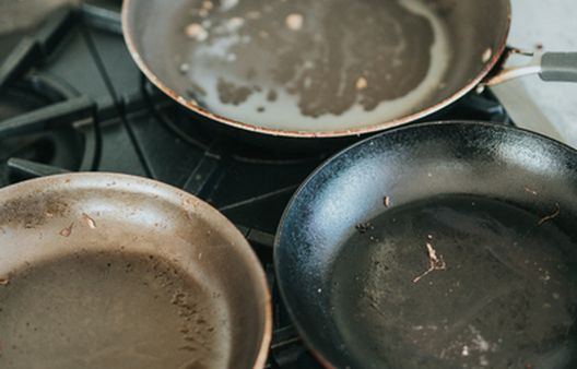 Dirty frying pans on gas hov oven top