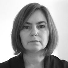 Woman with short brown hair wearing a black blouse in black and white headshotRachel Atkinson