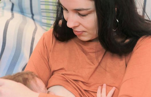 Close up of woman breastfeeding baby