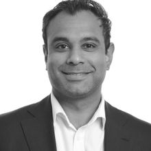 Headshot of man in a white shirt and black blazer black and white filterAmish Acharya