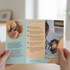 Person opening flyer on breastfeeding orange and blue colour